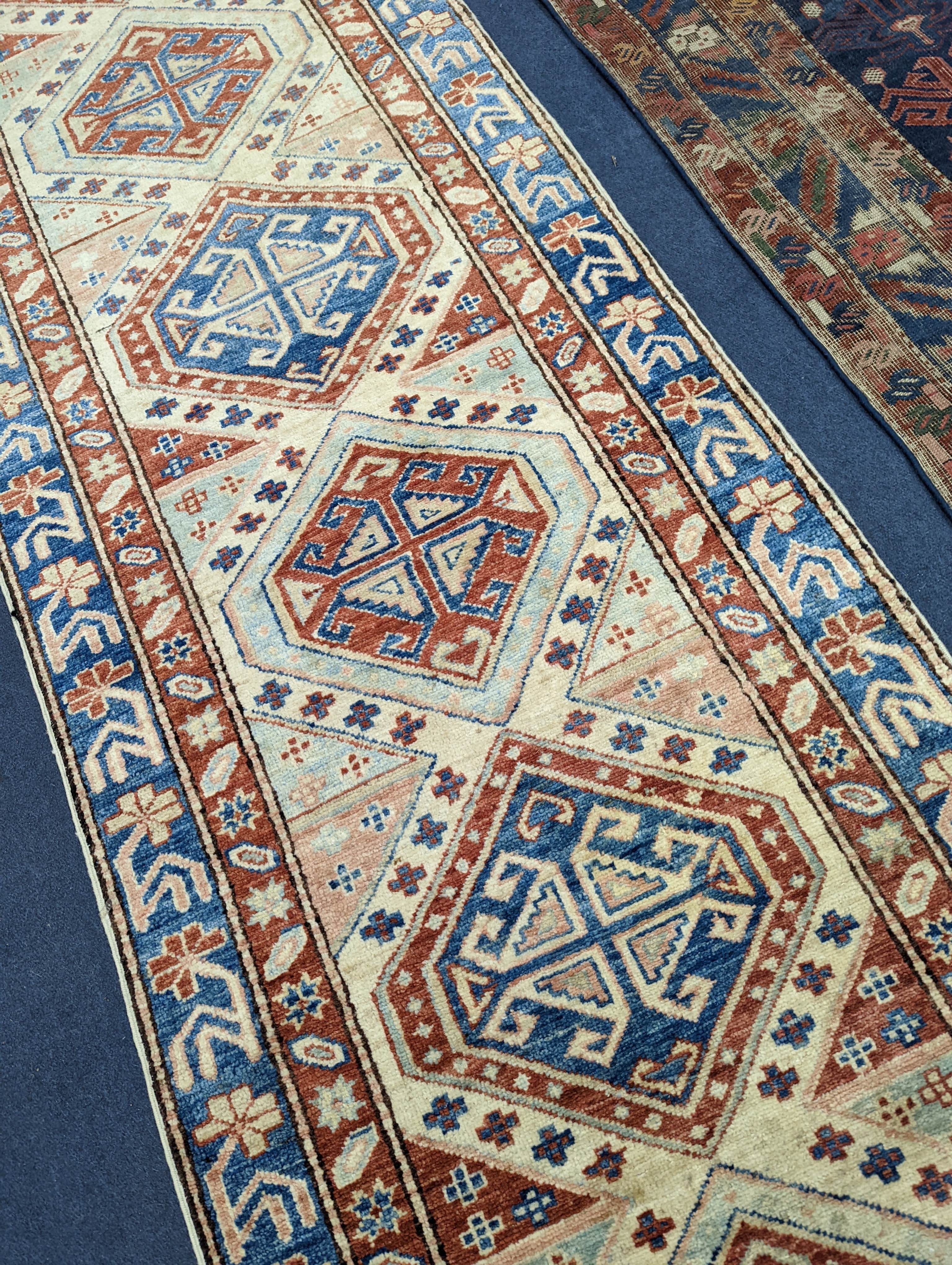 A Caucasian design ivory ground runner, 280 x 70cm